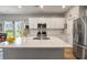 Modern kitchen featuring white cabinets, stainless steel appliances, and a large central island with ample counter space at 160 Greenbelt Ct, Summerville, SC 29485