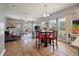 Inviting living room with wood floors, large windows and a decorative table with four red chairs at 160 Greenbelt Ct, Summerville, SC 29485