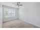 This neutral bedroom features a ceiling fan, carpet flooring and a window with backyard views at 166 Rosefield Ct, Summerville, SC 29485