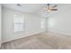 Well-lit bedroom with neutral carpet, ceiling fan, and large windows at 166 Rosefield Ct, Summerville, SC 29485