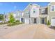 Inviting townhome exteriors with colorful siding, driveways, and landscaped front yards at 166 Rosefield Ct, Summerville, SC 29485