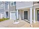 Exterior of townhome features a garage, and a covered porch with front door at 166 Rosefield Ct, Summerville, SC 29485