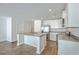 Open kitchen features stainless appliances, an island with sink, and white cabinetry at 166 Rosefield Ct, Summerville, SC 29485