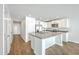 Open kitchen boasts stainless steel appliances, white cabinets, and an island sink at 166 Rosefield Ct, Summerville, SC 29485