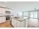 Modern kitchen features stainless steel appliances, an island with a sink, and white cabinets at 166 Rosefield Ct, Summerville, SC 29485