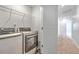 This laundry room features updated appliances, ample shelving for storage, and easy access to the hallway at 166 Rosefield Ct, Summerville, SC 29485