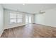 Open living area features wood-look floors, neutral walls, and a sliding glass door at 166 Rosefield Ct, Summerville, SC 29485