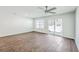 Bright living room features wood floors, ceiling fan, and sliding glass doors to backyard at 166 Rosefield Ct, Summerville, SC 29485