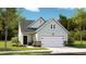 Charming, light green single-Gathering home with an attached garage and beautifully landscaped front yard at 188 Norse Bay, Summerville, SC 29486