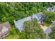 Aerial view of a well-maintained home with a grey roof, lush trees, and a red car in the driveway at 1972 Gray Battery Ct, Mount Pleasant, SC 29464