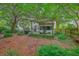 Tranquil backyard area with an outdoor patio, pergola, BBQ grill, and natural landscaping at 1972 Gray Battery Ct, Mount Pleasant, SC 29464