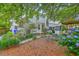 Beautiful backyard with patio, pergola, lush foliage and a charming seating area at 1972 Gray Battery Ct, Mount Pleasant, SC 29464