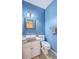 Bright blue bathroom with a vanity, undermount sink, and a decorative mirror and features modern fixtures at 1972 Gray Battery Ct, Mount Pleasant, SC 29464