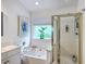Bathroom with a tub, stand up shower, vanity, and natural light creating a bright, spa-like atmosphere at 1972 Gray Battery Ct, Mount Pleasant, SC 29464