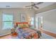 Inviting bedroom with warm natural light, decor, and features hardwood floors and large windows at 1972 Gray Battery Ct, Mount Pleasant, SC 29464