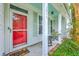 Inviting front porch with rocking chairs and a bright red screen door, adorned with classic shutters at 1972 Gray Battery Ct, Mount Pleasant, SC 29464