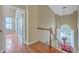 Bright hallway with wooden floors, staircase, and trim around doorways creating an elegant transition between spaces at 1972 Gray Battery Ct, Mount Pleasant, SC 29464