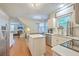 Modern kitchen with stainless appliances, marble countertop, and view into the dining and living area at 1972 Gray Battery Ct, Mount Pleasant, SC 29464