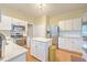 Bright kitchen featuring white cabinets, stainless steel appliances, and an island with stone countertop at 1972 Gray Battery Ct, Mount Pleasant, SC 29464