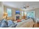 Inviting living room features a cozy fireplace, ceiling fan, and access to a screened porch at 1972 Gray Battery Ct, Mount Pleasant, SC 29464