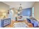 Stylish living room with hardwood floors, modern lighting, chair, piano and a serene blue accent wall at 1972 Gray Battery Ct, Mount Pleasant, SC 29464