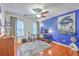 Bright office space with hardwood floors, ceiling fan, desk, and large blue heron art print at 1972 Gray Battery Ct, Mount Pleasant, SC 29464