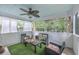 Enclosed back patio with cushioned seating, coffee table, and a ceiling fan for outdoor comfort at 1972 Gray Battery Ct, Mount Pleasant, SC 29464