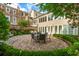 Beautiful backyard featuring a dining set on a circular brick patio and lush landscaping at 2 Bedons Aly, Charleston, SC 29401