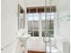 Bright bathroom with a pedestal sink, glass enclosed shower, and natural light at 2 Bedons Aly, Charleston, SC 29401