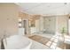 Bright primary bathroom with soaking tub, double vanities, and a glass shower at 2 Bedons Aly, Charleston, SC 29401