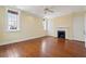 Spacious bedroom with hardwood floors, neutral walls, and ample natural light from large windows at 2 Bedons Aly, Charleston, SC 29401