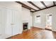 Charming bedroom with hardwood floors, fireplace, closet, and exposed wood beams at 2 Bedons Aly, Charleston, SC 29401