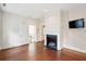 Bedroom featuring a fireplace, hardwood floors, and access to the stairway at 2 Bedons Aly, Charleston, SC 29401