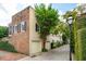 Charming home exterior featuring brick accents, mature trees, and a well-maintained yard at 2 Bedons Aly, Charleston, SC 29401