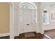 Bright foyer showcasing a classic white front door, elegant hardwood floors, and traditional molding at 2 Bedons Aly, Charleston, SC 29401