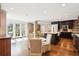 Modern eat-in kitchen boasts a large island, stainless steel appliances, and brick accent wall at 2 Bedons Aly, Charleston, SC 29401