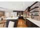 Kitchen with black cabinets, stainless steel appliances, brick accent wall and open shelving at 2 Bedons Aly, Charleston, SC 29401