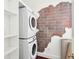 Convenient laundry room features stacked washer and dryer with built-in storage at 2 Bedons Aly, Charleston, SC 29401