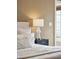 Cozy bedroom featuring a padded headboard, bedside table with lamp, and natural light from a window at 2 Bedons Aly, Charleston, SC 29401