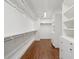 Large walk-in closet featuring custom shelving and ample storage space at 2 Bedons Aly, Charleston, SC 29401