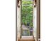 Scenic window view overlooking lush greenery and a charming outdoor area with decorative ironwork at 2 Bedons Aly, Charleston, SC 29401