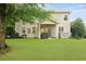Spacious backyard with lush green lawn, mature trees, and a covered patio for outdoor enjoyment at 200 Commencement Blvd, Ladson, SC 29456