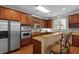 Spacious kitchen featuring stainless steel appliances, wood cabinets, breakfast bar and granite countertops at 200 Commencement Blvd, Ladson, SC 29456