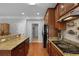 Bright kitchen featuring dark wood cabinets, granite countertops and modern stainless steel appliances at 200 Commencement Blvd, Ladson, SC 29456