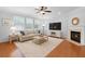 Cozy living room with hardwood floors, fireplace, and a comfortable sofa with decorative pillows at 200 Commencement Blvd, Ladson, SC 29456