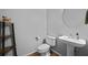 Cozy powder room with pedestal sink, decorative mirror, and wood flooring at 200 Commencement Blvd, Ladson, SC 29456
