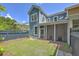 View of the backyard showing the lawn, patio, and screened porch at 2036 Kings Gate Ln, Mount Pleasant, SC 29466