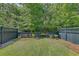 Backyard with green grass, fence, and mature trees providing shade at 2036 Kings Gate Ln, Mount Pleasant, SC 29466