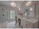Bright bathroom featuring double sinks, a vanity with chair, and a glass enclosed shower at 2036 Kings Gate Ln, Mount Pleasant, SC 29466