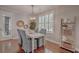 Stylish dining area with hardwood floors, a modern light fixture, and ample natural light at 2036 Kings Gate Ln, Mount Pleasant, SC 29466